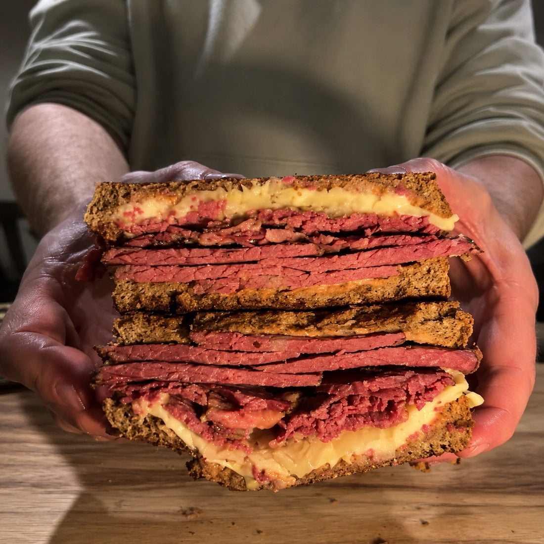 Homemade smoked pastrami Reuben sandwich with thinly sliced pastrami, sauerkraut and Swiss cheese