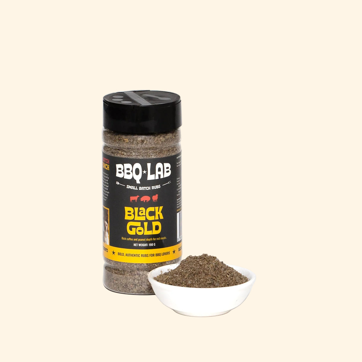 BBQ LAB Black Gold coffee and peanut butter BBQ rub bottle beside a bowl of seasoning