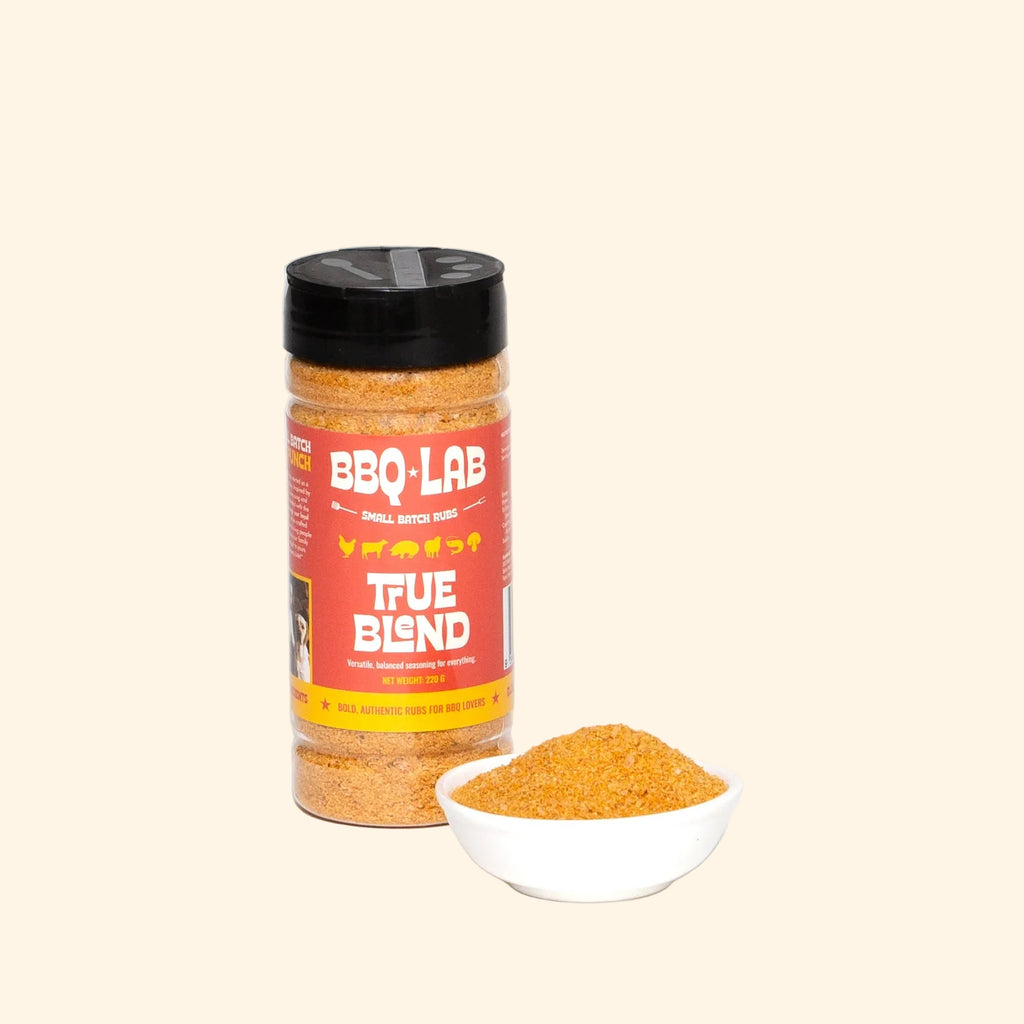 BBQ Lab True Blend seasoning jar with a small bowl of seasoning on a white background